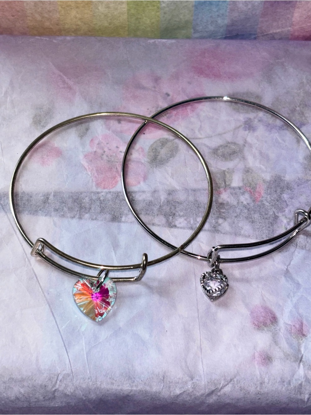 2 bangle bracelets with heart shaped charms